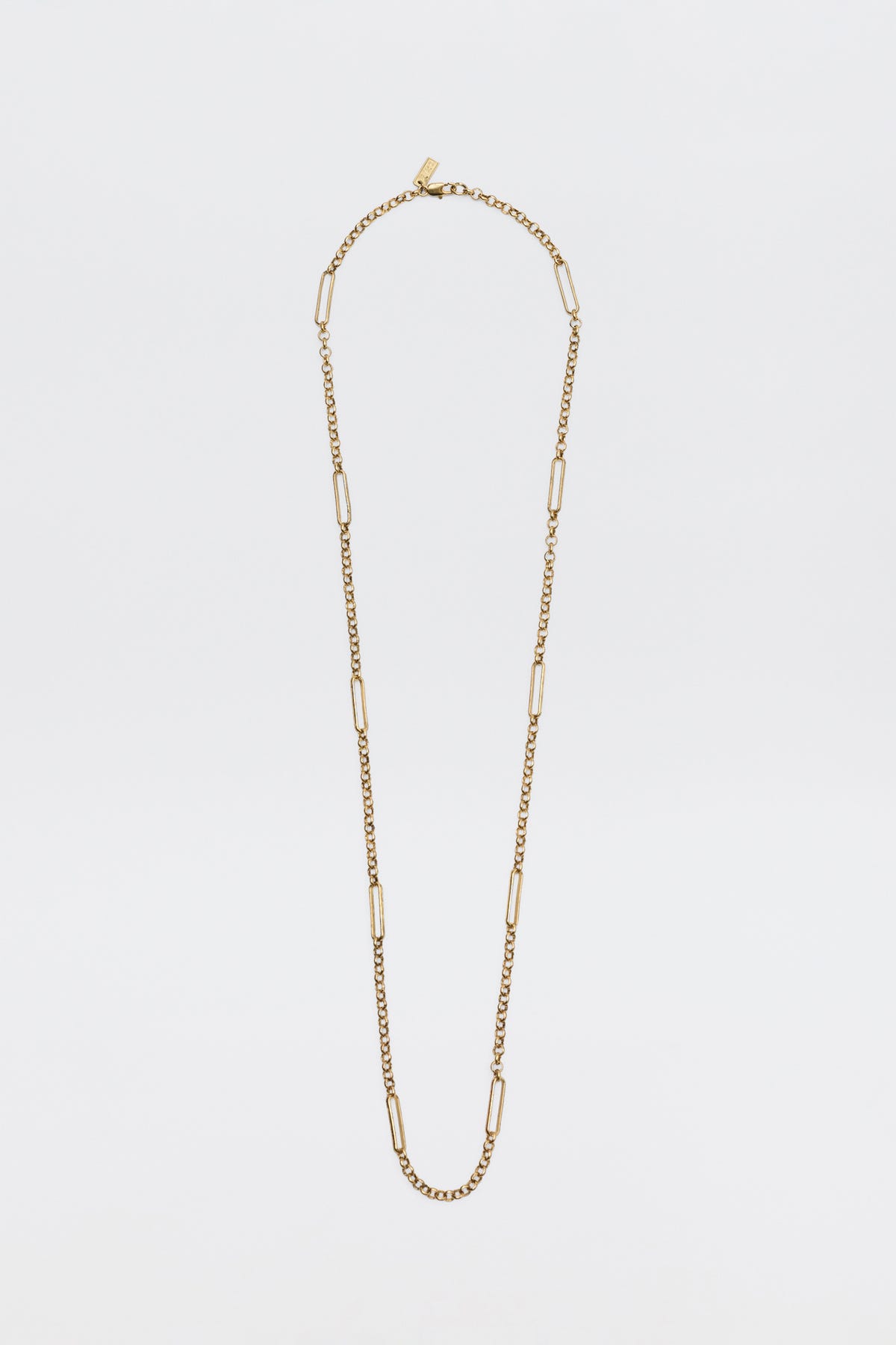 The Eta - Gold necklace, featuring alternating small curb chain links and elongated rectangular links, is displayed against a plain white background.