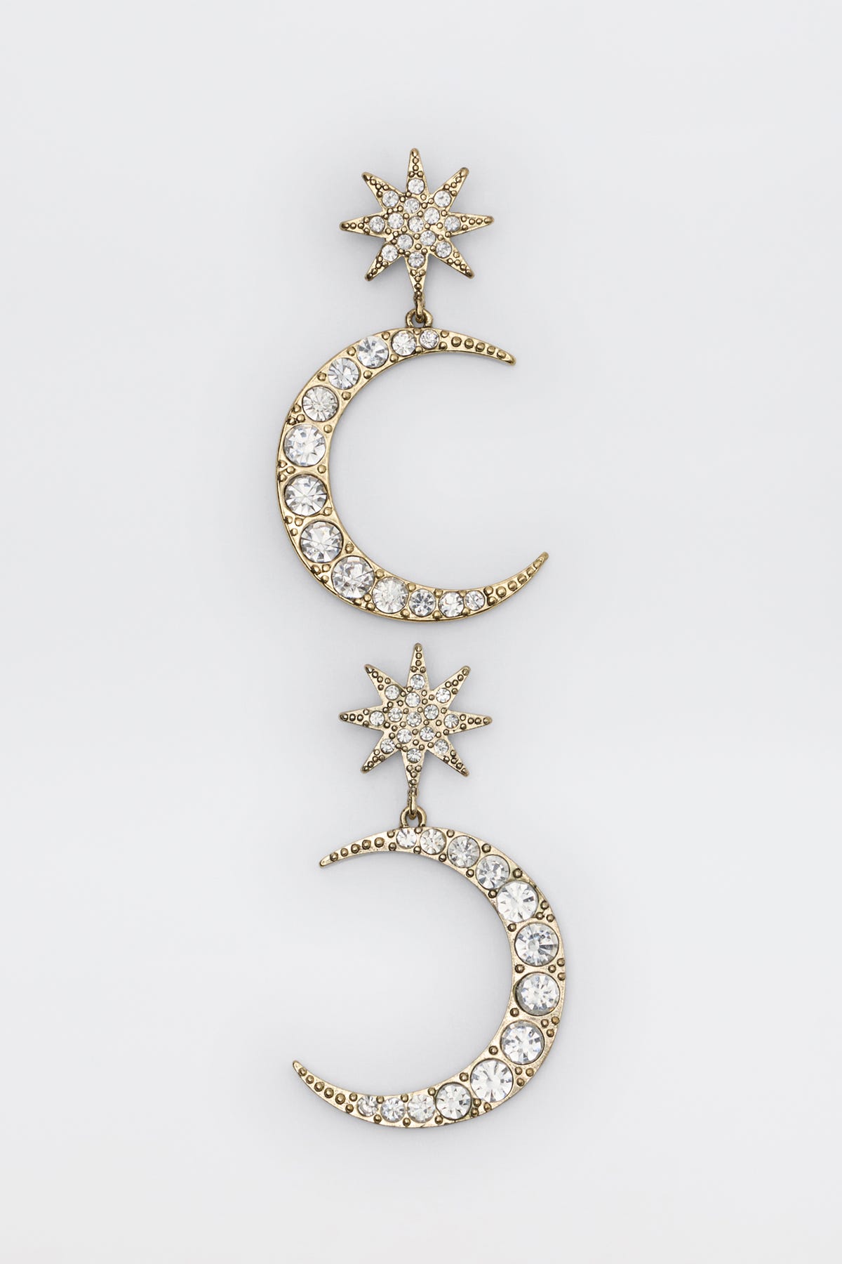Theresa - Gold earrings featuring a gold-tone star and crescent moon drop design encrusted with clear crystals.