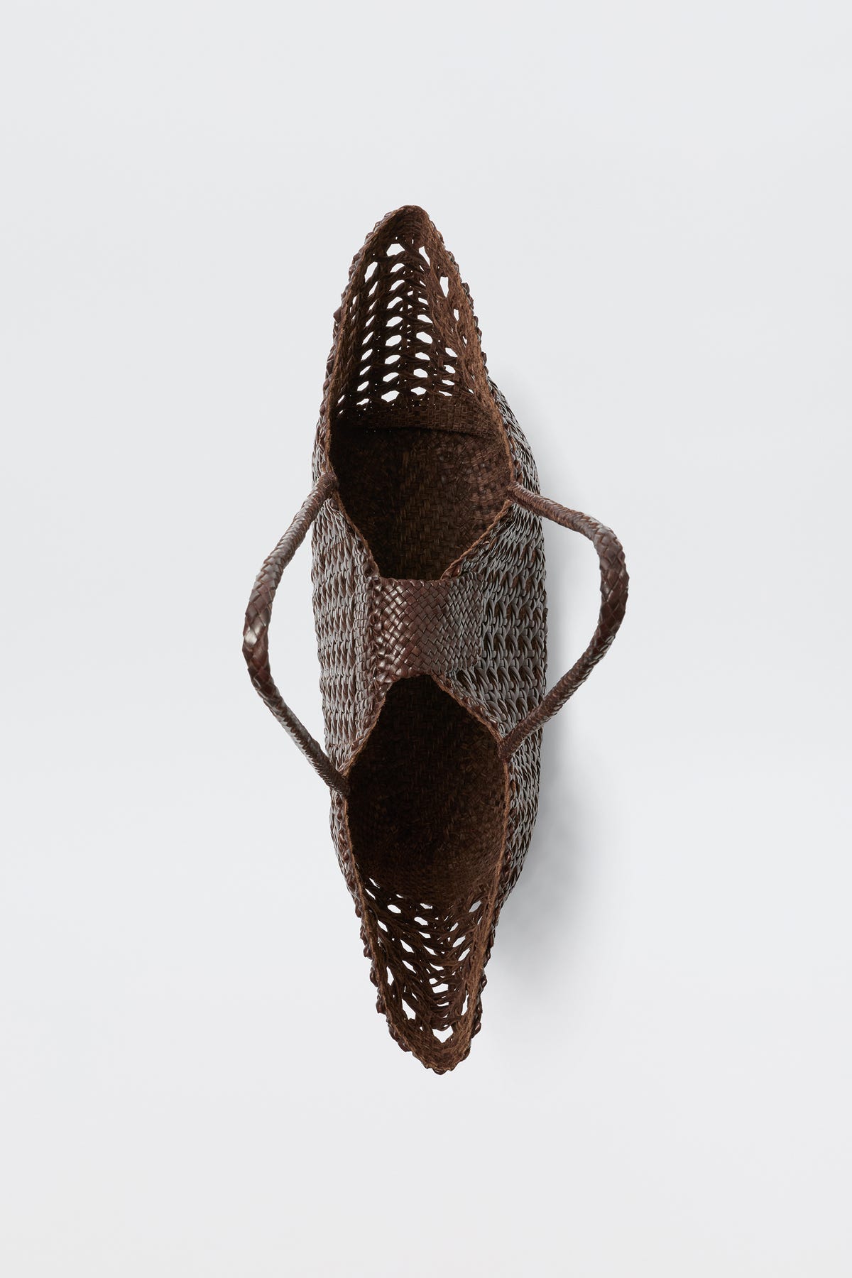 A top-down view of an empty, dark brown woven basket bag with two handles, placed against a plain white background—this is the Lucine – Dark Brown, celebrated for its classic leather woven style.