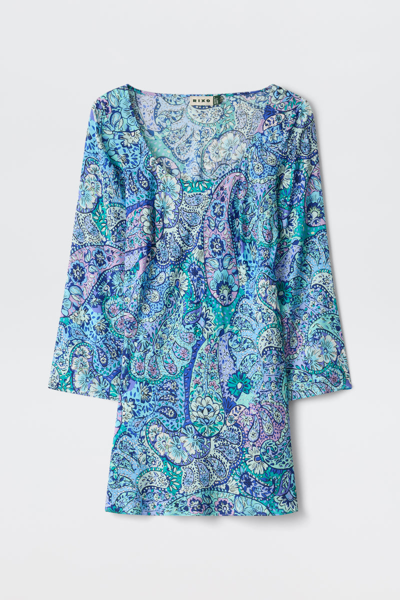 The Dulce - Paisley Floral Blue dress is a long-sleeve, scoop-neck design featuring a blue, teal, and purple paisley pattern, displayed flat against a white background.