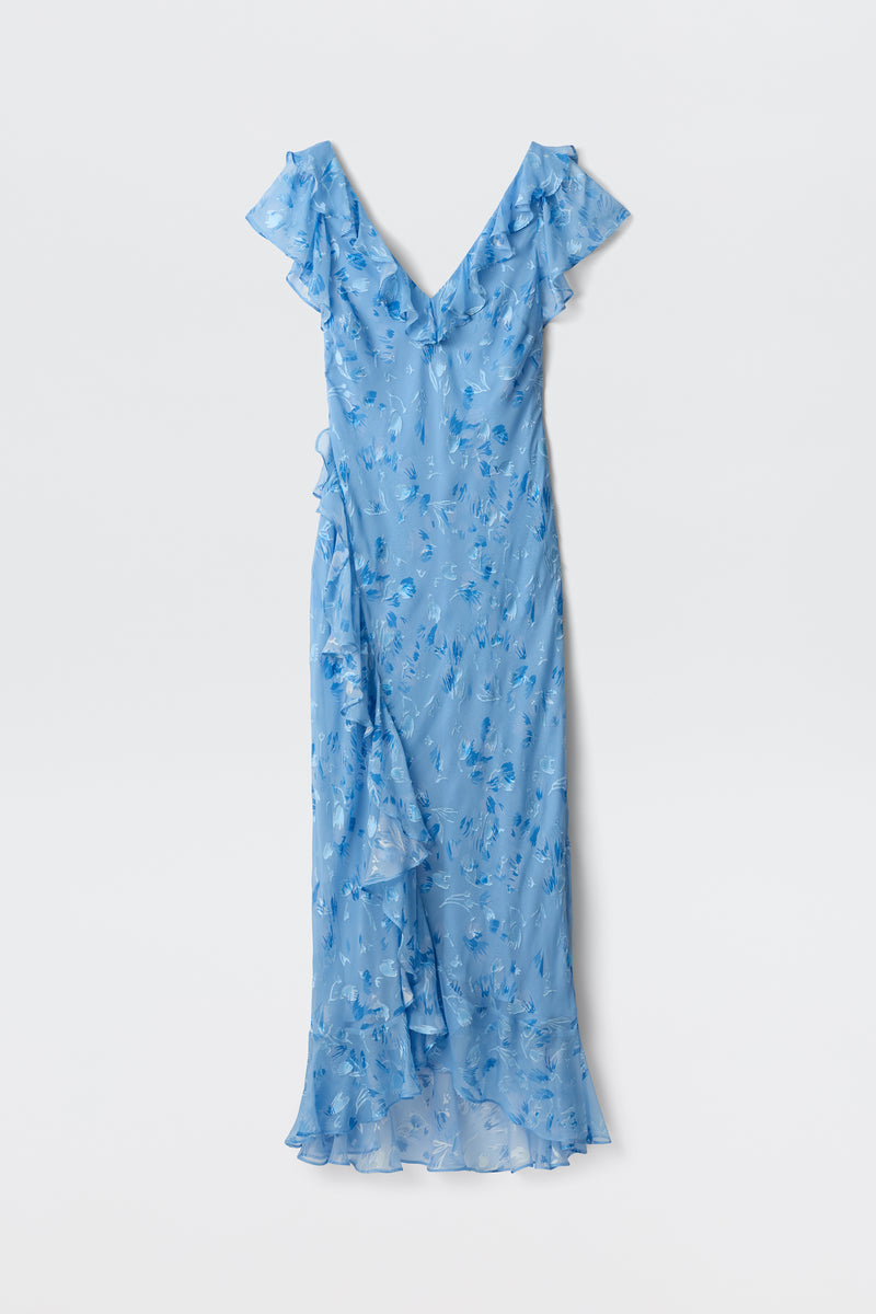 The Meadow - Ava Devore Blue is a sleeveless, light blue maxi dress with ruffles, a V-neckline, and a floral pattern, shown flat on a white background.