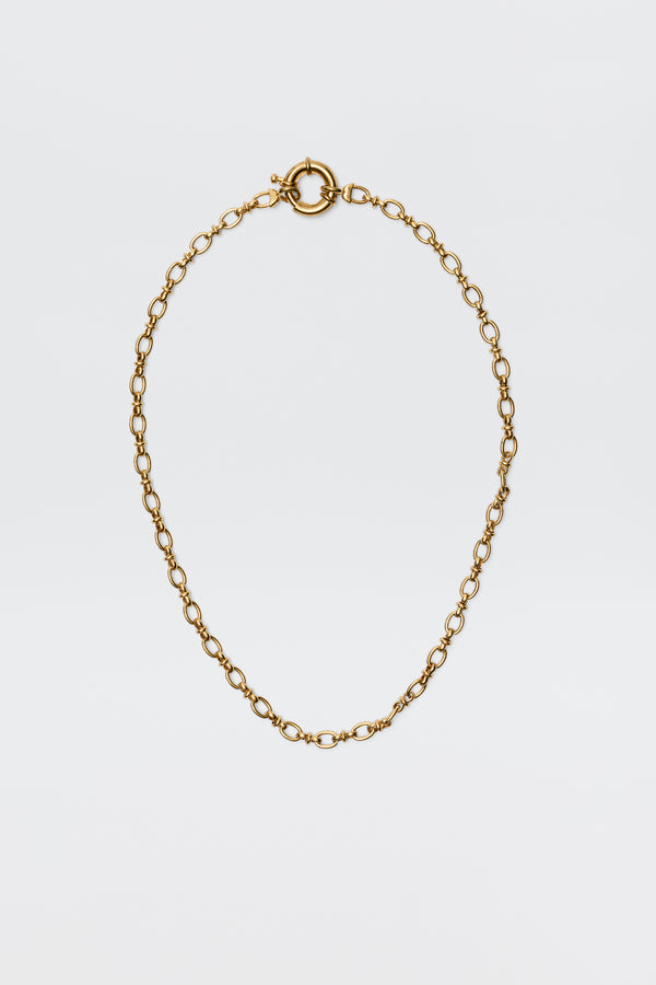 The Lorene - Gold is a vintage-inspired gold-plated necklace with oval links and a round spring ring clasp, elegantly showcased against a plain white background.