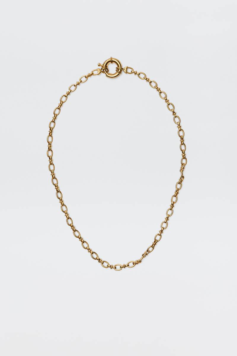 The Lorene - Gold is a vintage-inspired gold-plated necklace with oval links and a round spring ring clasp, elegantly showcased against a plain white background.