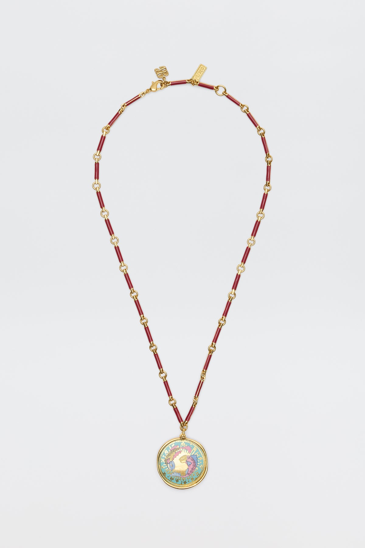 Ari - Astro Pisces: A gold and red beaded necklace featuring a circular statement disc pendant with a colorful rooster design on a white background, displayed against a white surface.