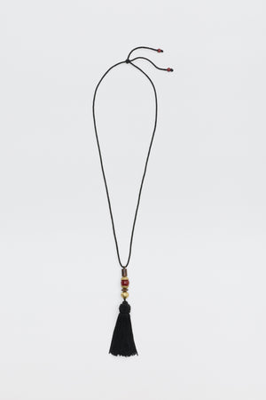 Rossa - Black cord necklace featuring gold and red accent beads and a black tassel pendant.
