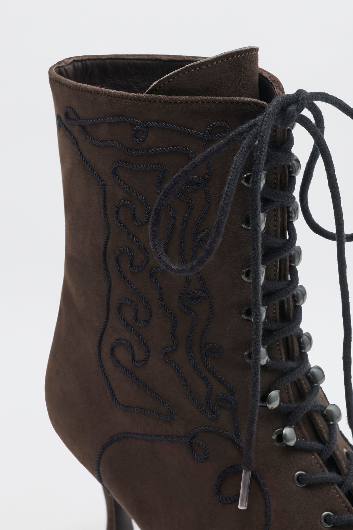 Victoriana - Brown ankle boot with a lace-up front and decorative dark embroidery on the side.