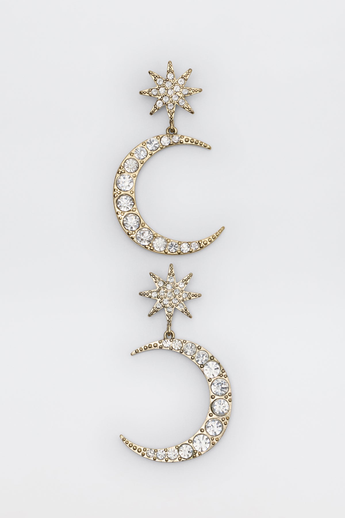 Theresa - Gold earrings featuring a gold-tone star and crescent moon drop design encrusted with clear crystals.