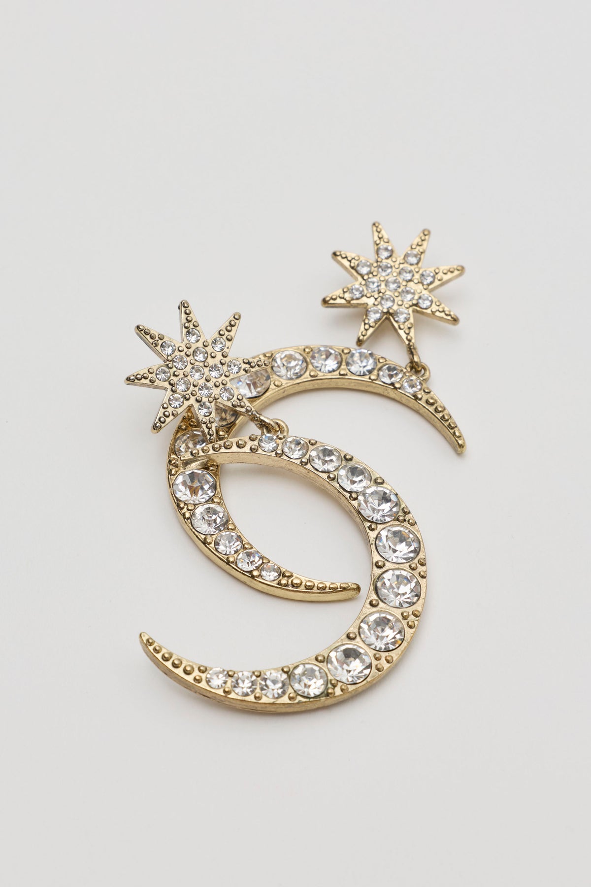 Theresa - Gold brooch featuring two stacked crescent moons and two star-shaped accents, all encrusted with clear crystals.