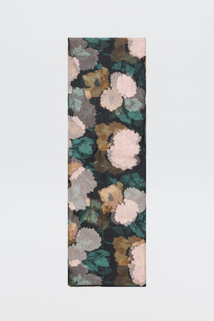 A rectangular piece of “Julien - Hydrangea Floral Charcoal” fabric featuring a floral pattern in muted pink, green, brown, and beige tones set against a dark charcoal background, displayed on a plain white surface.