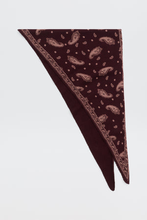 Lianora - Daisy Paisley Knit Oxblood triangular scarf in dark red with a light-colored paisley pattern and a decorative border.
