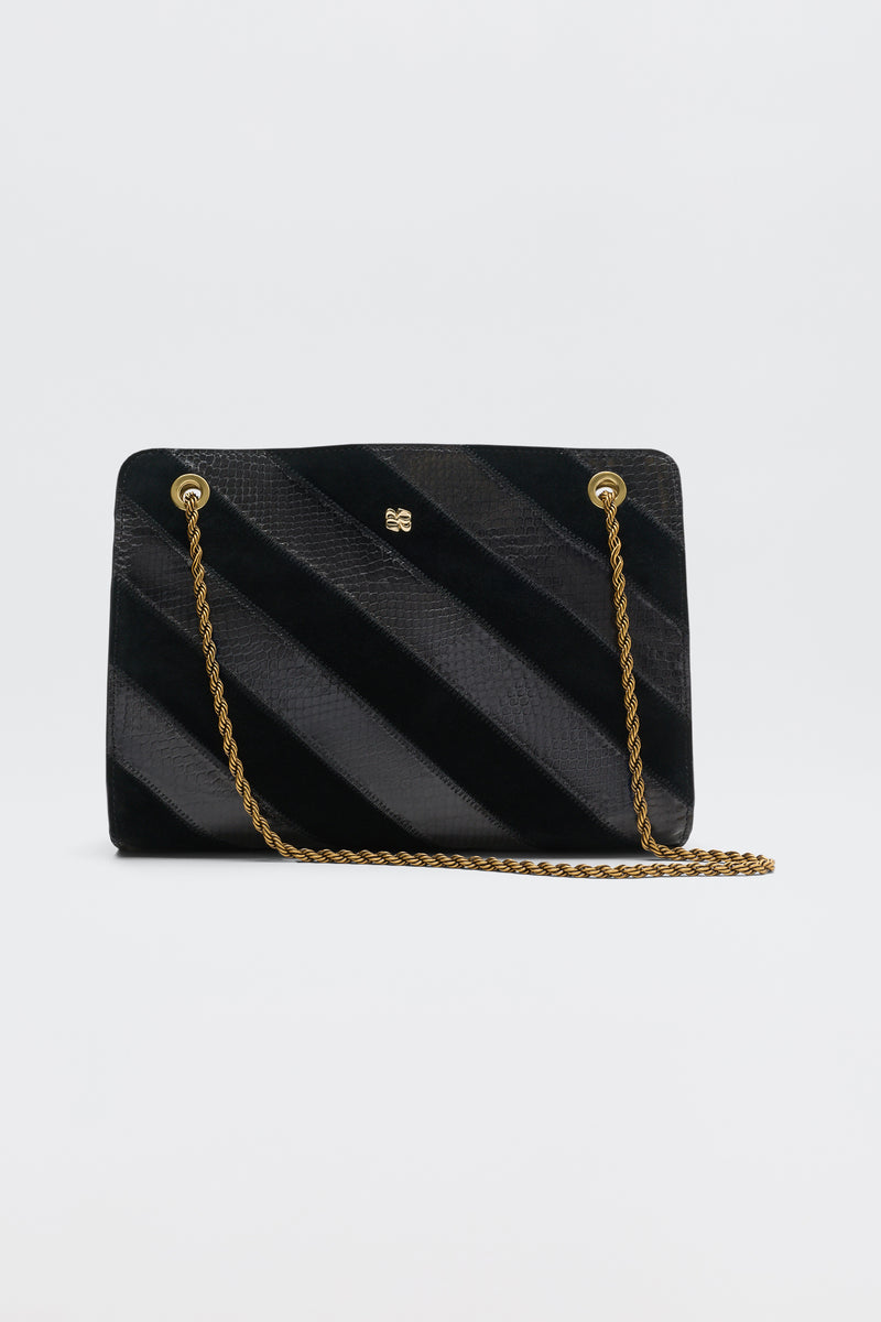 Eleina - Black handbag featuring alternating diagonal stripes of textured and smooth material, a gold chain shoulder strap, and a small gold logo.