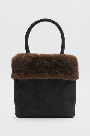 Gabbie - Black handbag with a brown faux-fur trim and a single top handle.