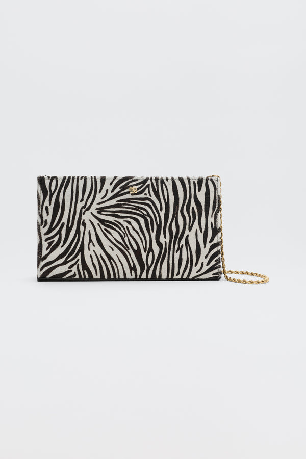 Kamila - Zebra Print Brown rectangular clutch bag with a brown and cream zebra print and a gold-tone chain strap.