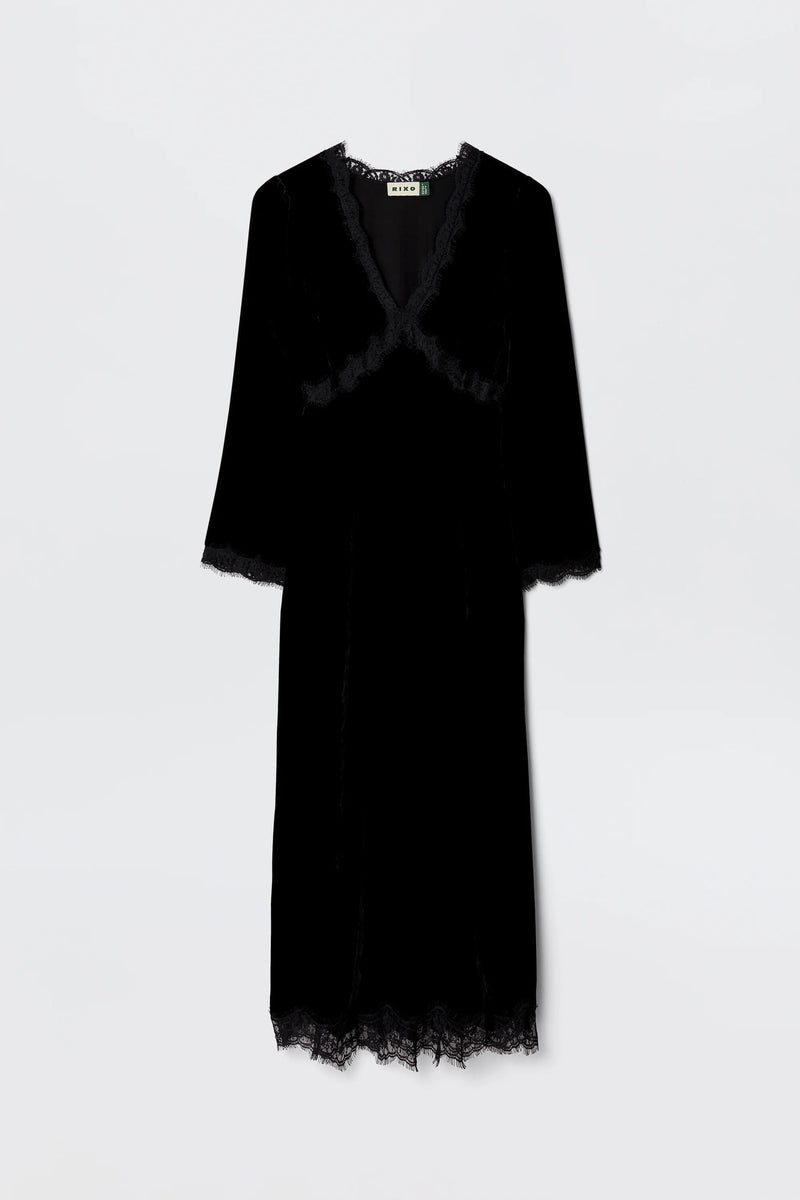 The Alessi - Black is a long-sleeved black velvet dress with boho-glam lace detailing on the neckline, sleeves, and hem, shown against a plain light background.
