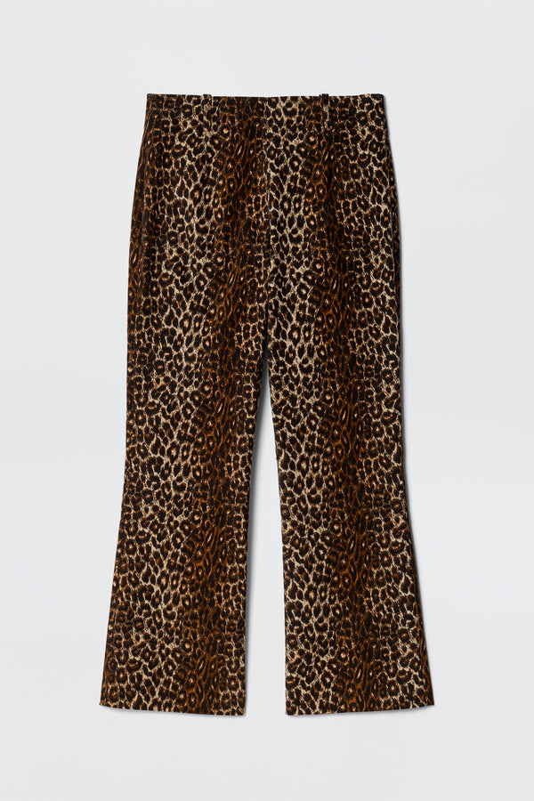 The Olwen - Lyra Leopard Black is a pair of vintage-inspired, high-waisted wide-leg trousers with a brown and black leopard print, shown laid flat on a white background.