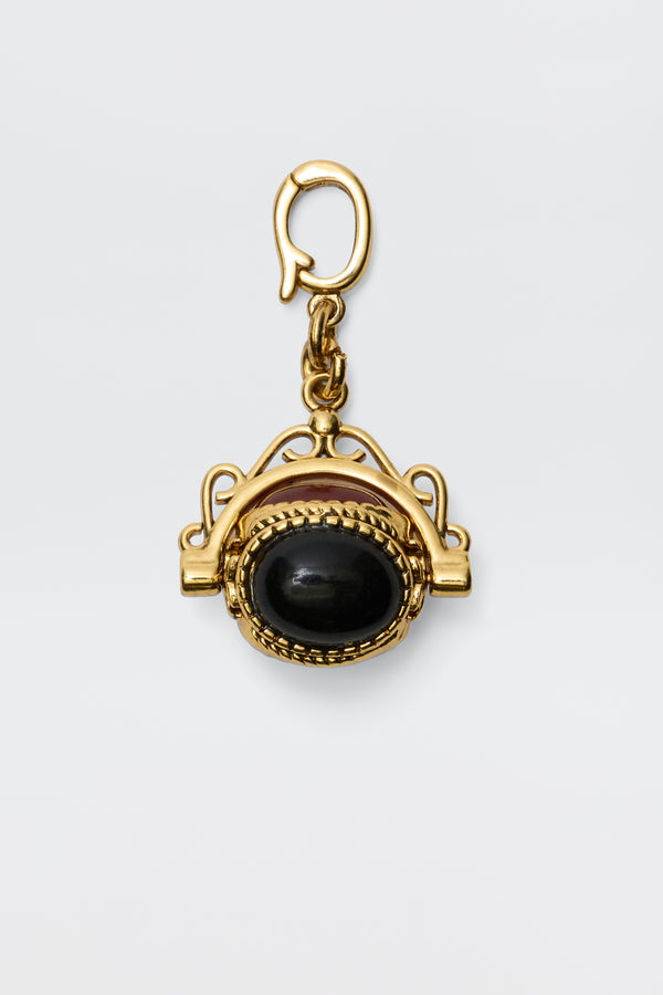 Sariah - Gold is an 18-karat gold-plated pendant featuring a large oval semi-precious stone in an intricate frame, hanging from a decorative clasp and radiating vintage charm against a plain white background.