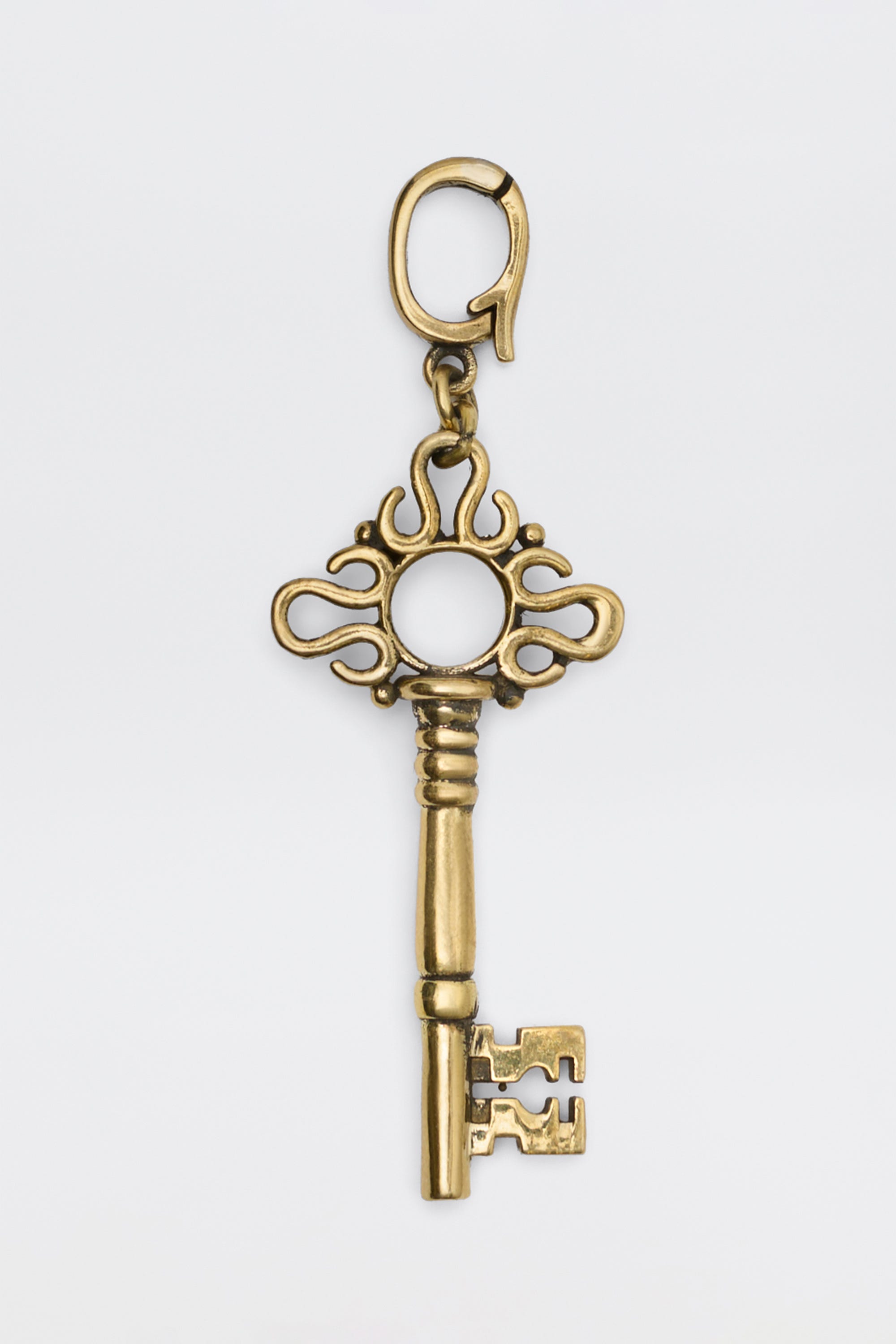 Arleth - Gold decorative key charm with an ornate bow and a lobster clasp.