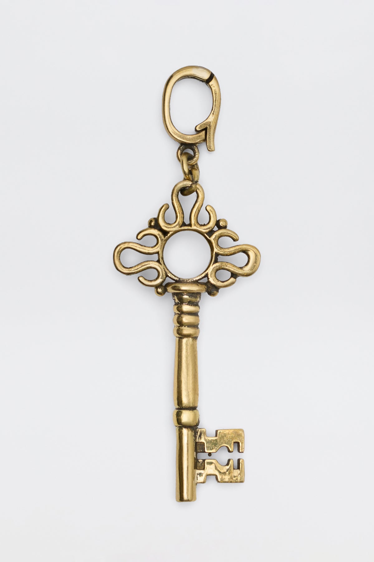 Arleth - Gold decorative key charm with an ornate bow and a lobster clasp.
