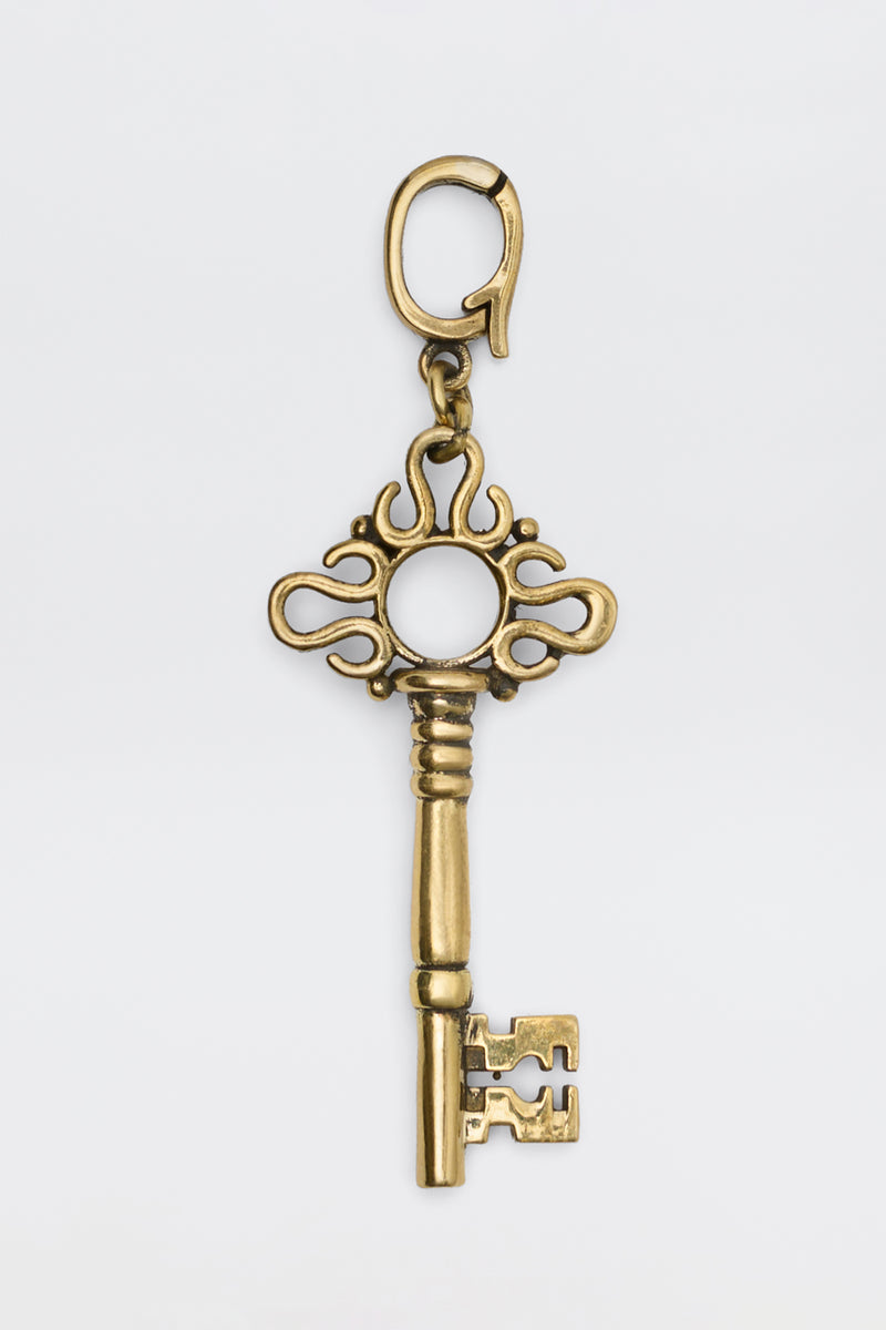 Arleth - Gold decorative key charm with an ornate bow and a lobster clasp.