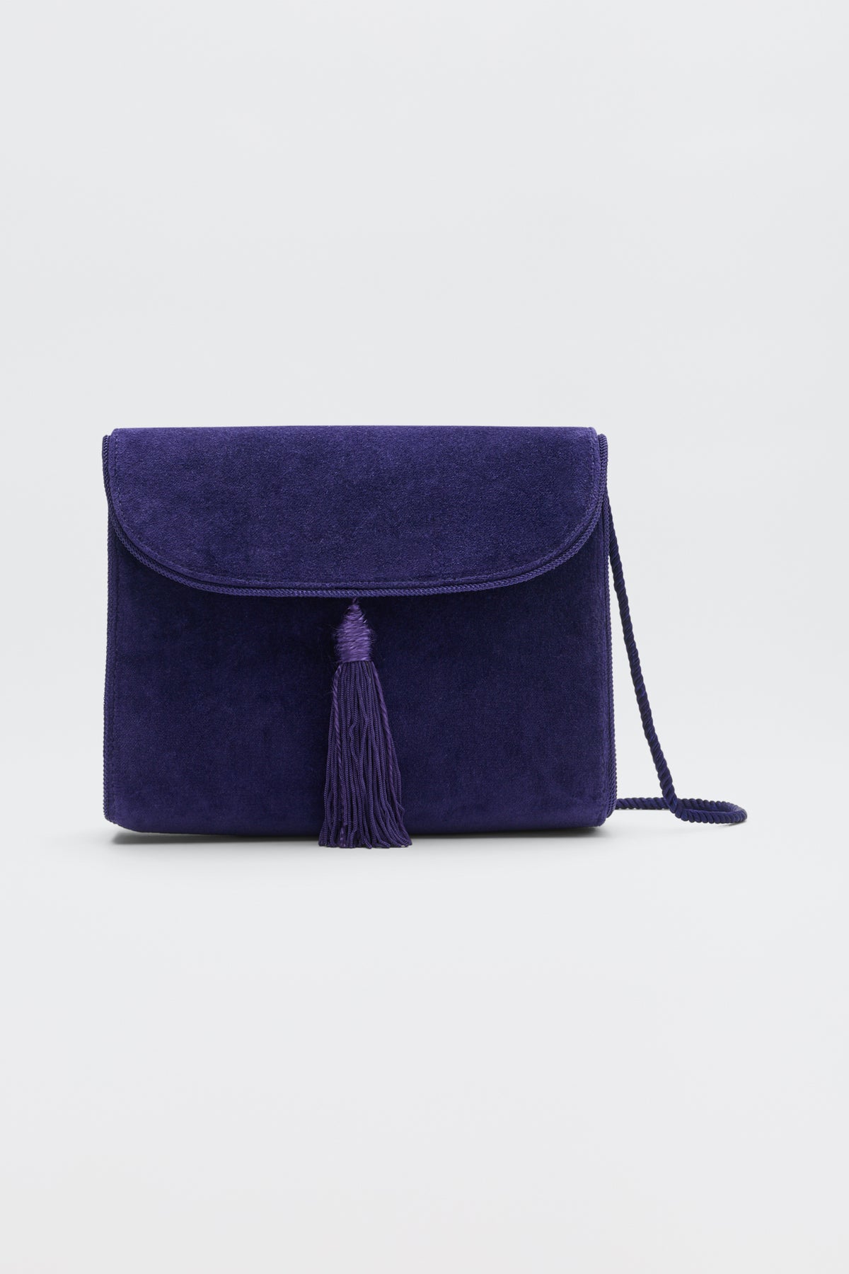 Jeany - Purple suede shoulder bag featuring a fold-over flap, a central tassel, and a thin strap.