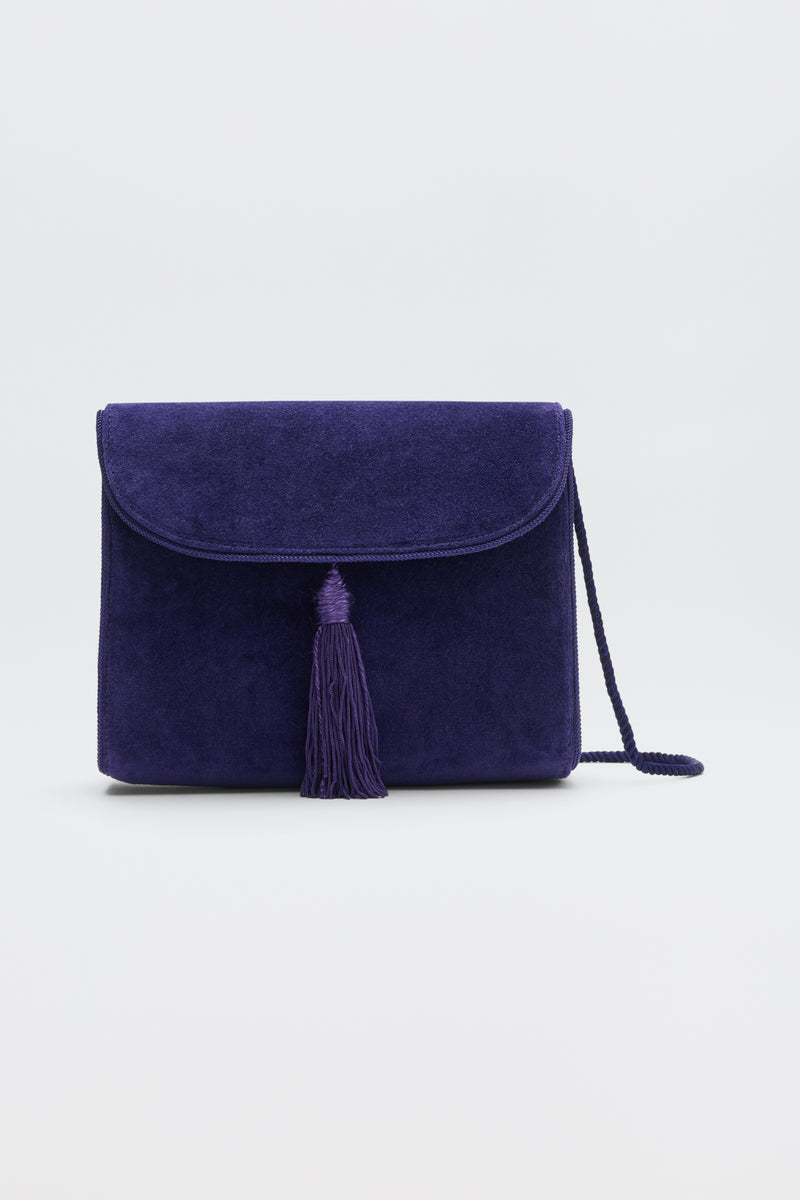 Jeany - Purple suede shoulder bag featuring a fold-over flap, a central tassel, and a thin strap.