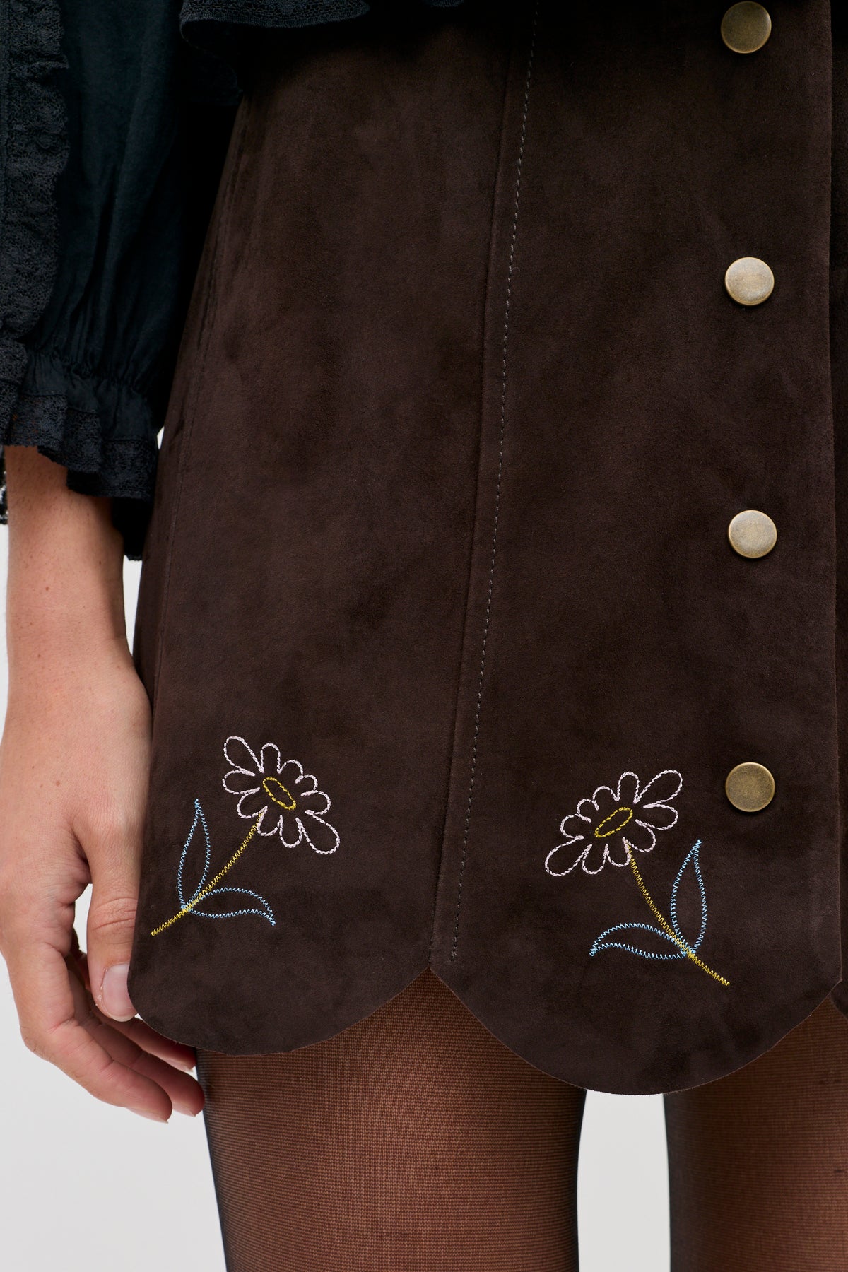 Caris - Shasta Daisy Embroidery Chocolate skirt in dark brown with a button-down front, scalloped hem, and embroidered daisy flower designs.