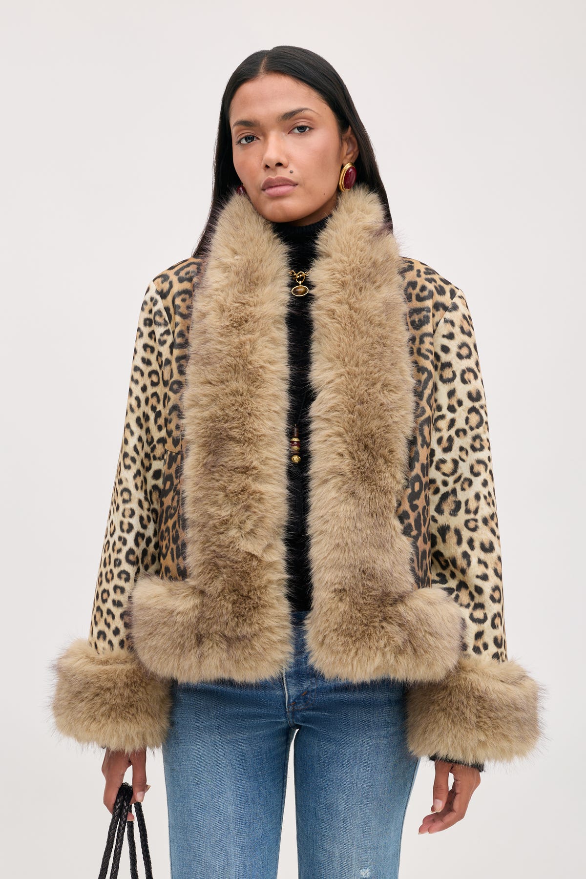 A model wears a Jorgia - Savannah Leopard Brown jacket featuring a brown leopard print with a thick, tan faux-fur collar and cuffs.