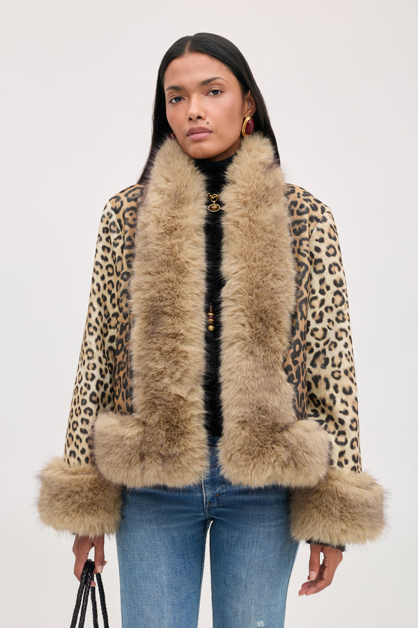 A model wears a Jorgia - Savannah Leopard Brown jacket featuring a brown leopard print with a thick, tan faux-fur collar and cuffs.