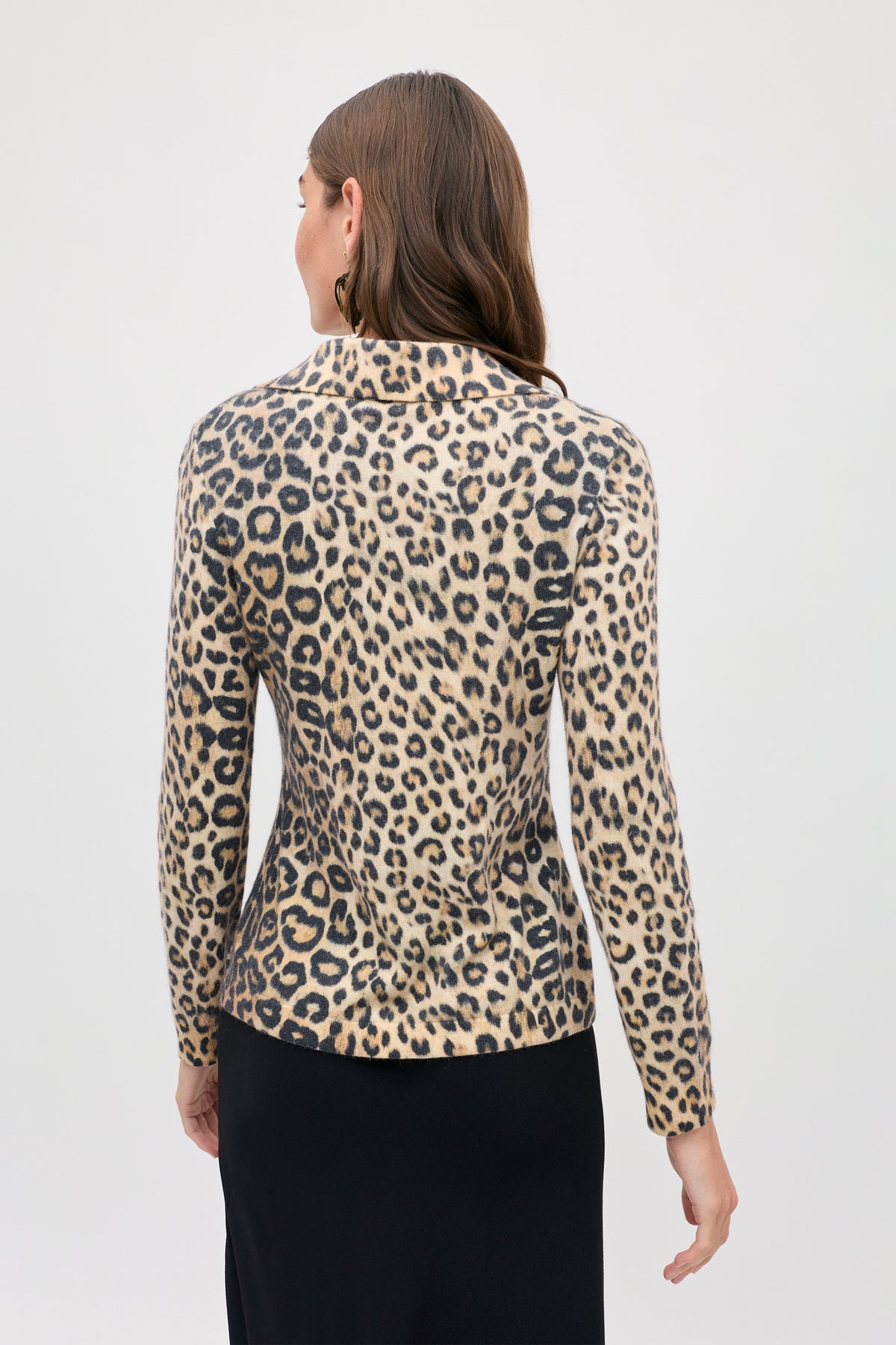 A person viewed from the back wearing a long-sleeved, collared Kristy - Savannah Leopard Brown top.