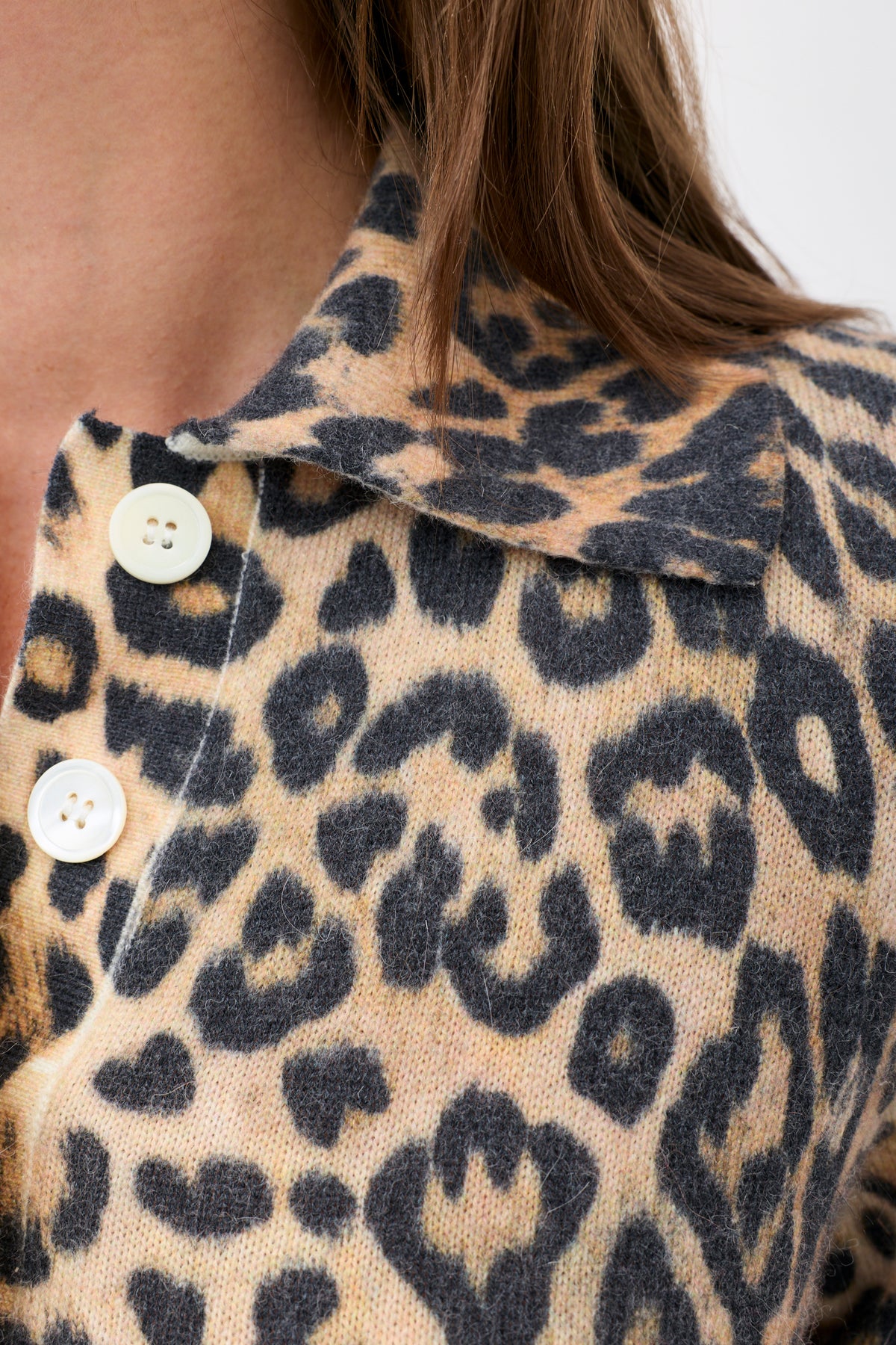 Kristy - Savannah Leopard Brown knit polo shirt with two white buttons at the collar.