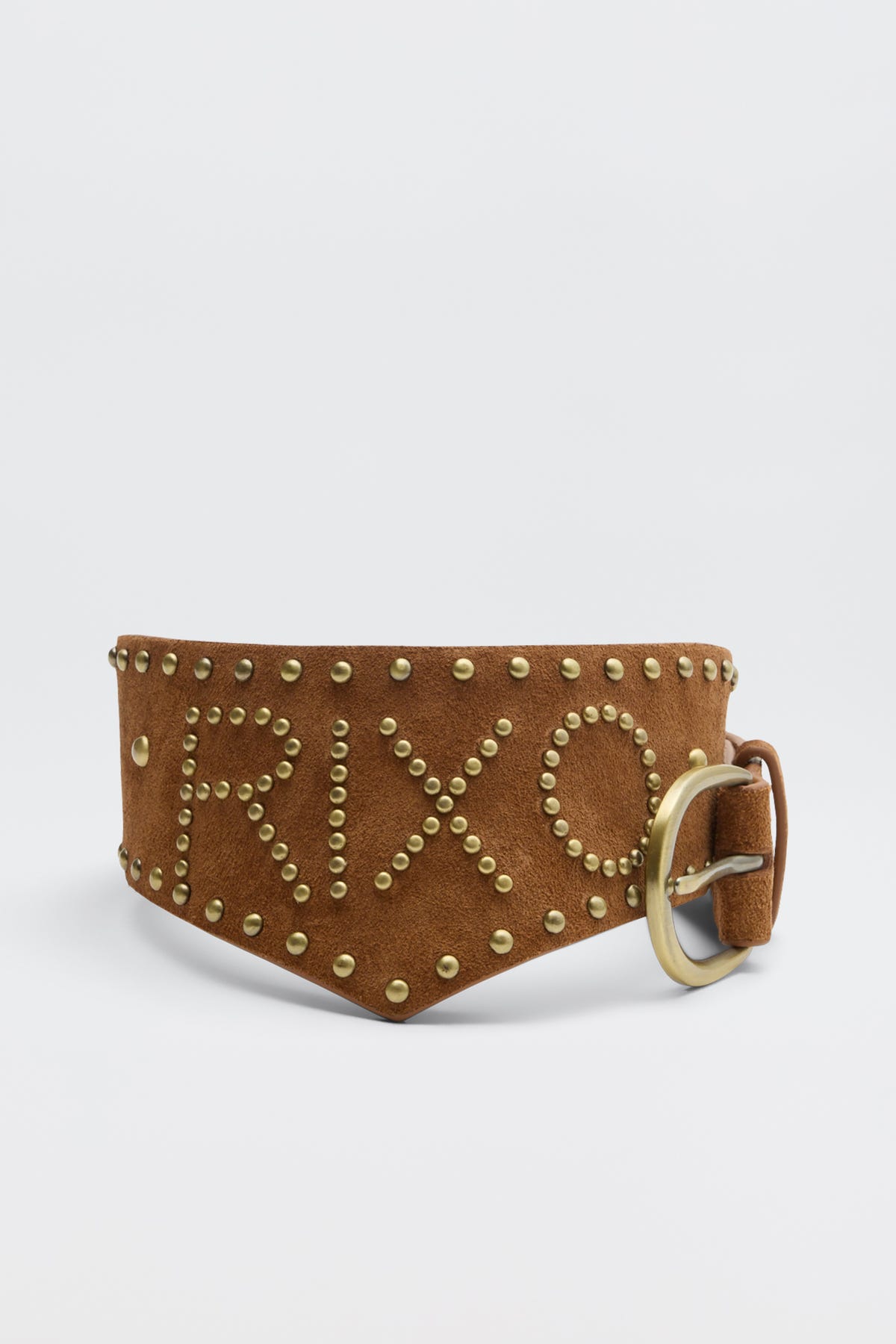 The Lorelei - Camel is a wide brown suede belt with gold studs spelling out RIXO, extra studs along the edges, and a gold buckle on the right.