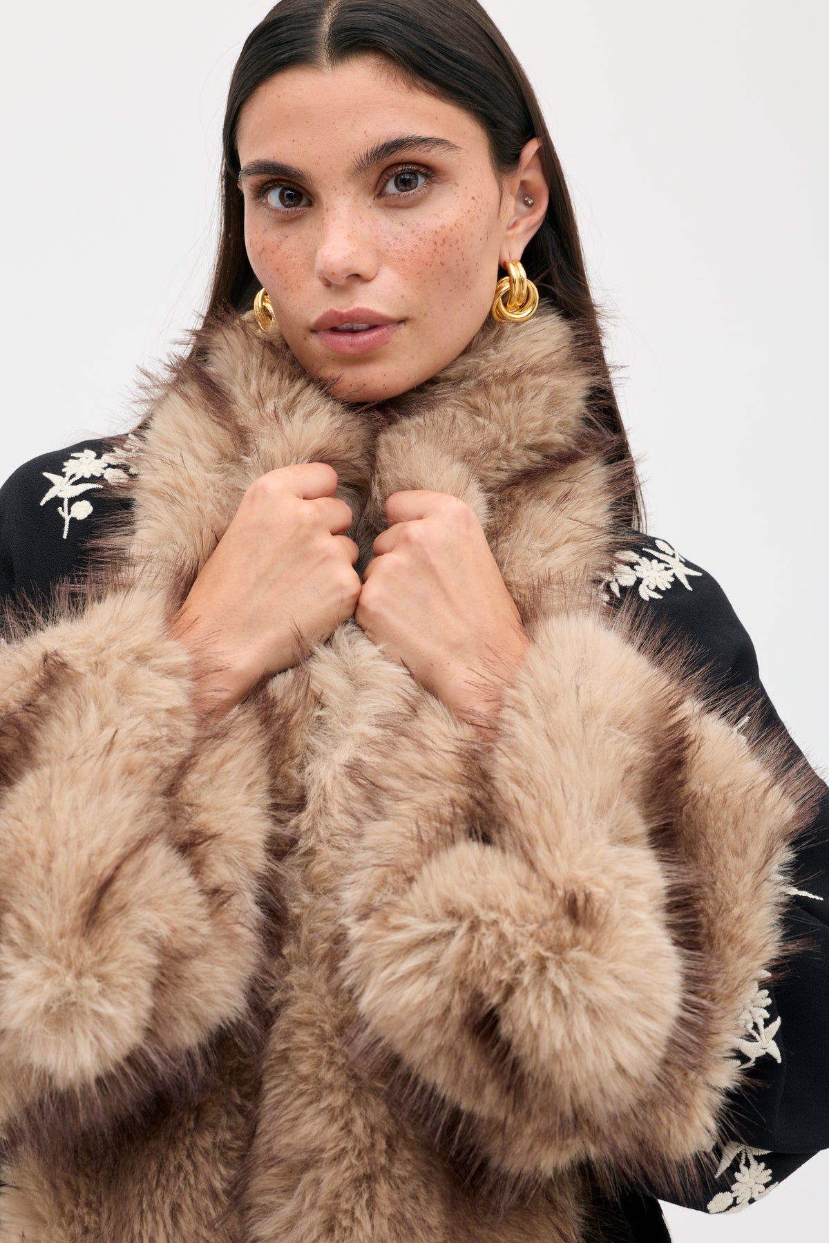 The Micah - Alexa Flower Embroidery Black jacket features white flower embroidery and large faux fur trim on the collar and cuffs.